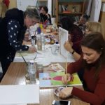 workshop participants painting portraits together