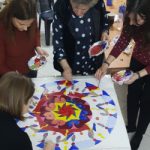 team building participants painting a mosaic together