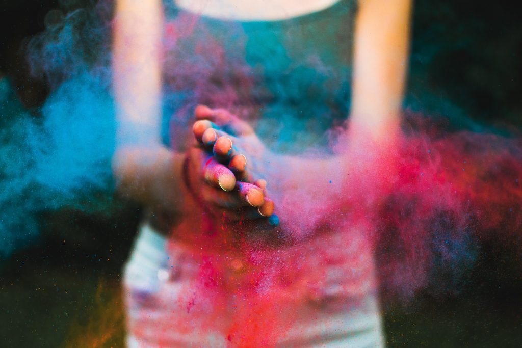 a person packing colourful powder, symbolising wellness packages for individuals